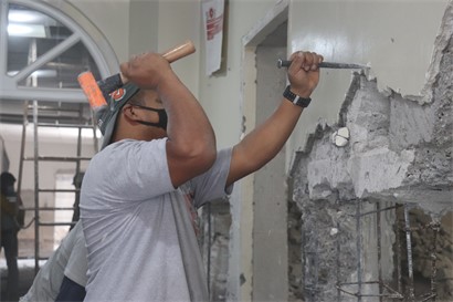 Man Hammering wall - construction